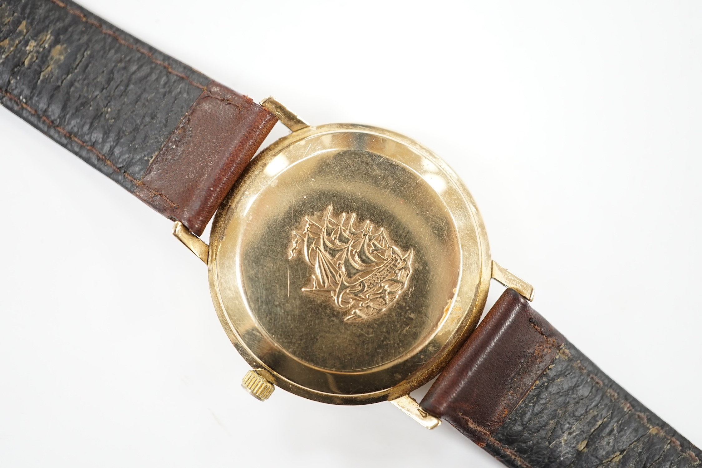 A gentleman's 9ct gold Longines Flagship automatic wrist watch, with baton numerals and date aperture, on associated leather strap.